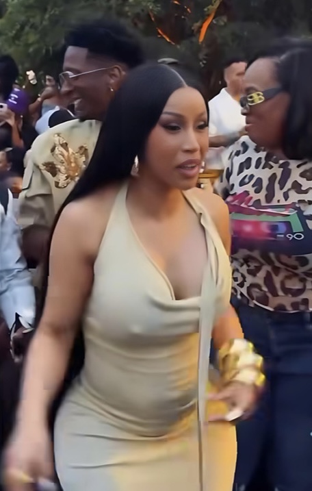 Cardi B arriving at an event in a beige dress